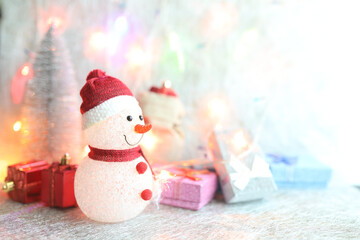 Snow man and Gift boxes and Christmas bright lights
