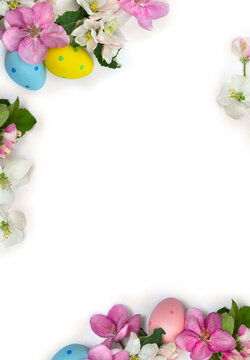 Easter decoration. Pink and white flowers apple tree with Easter eggs with space for text on a light background. Top view, flat lay