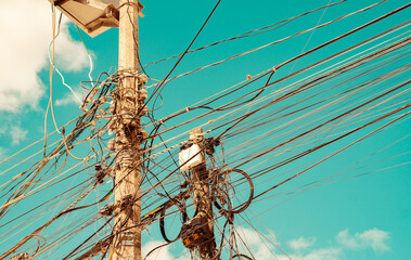 A tropical sky behind a mess of  power lines in Mexico.
