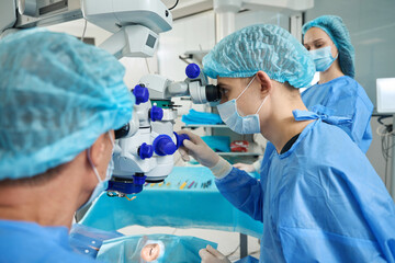 Surgeons doing a laser vision correction operation