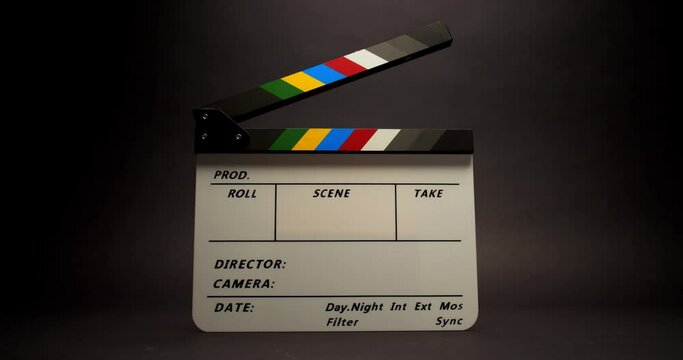 Film clapperboard, fixed and blank clapperboard on black background, zoom-in motion and 4K macro shooting