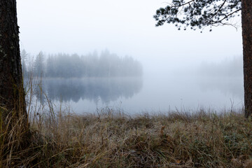 Fototapeta na wymiar Foggy and cold late autumn morning by the lake in Finland