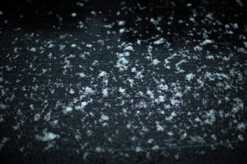 Snow on glass. Snow on car window. After snowstorm. Precipitation on surface.