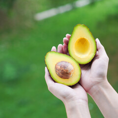 Whole and cut avocados on table. Space for text