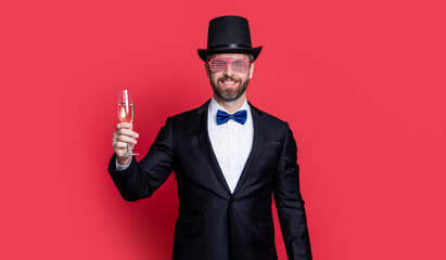 man magician cheering isolated on red background. magician man in cylinder hat.