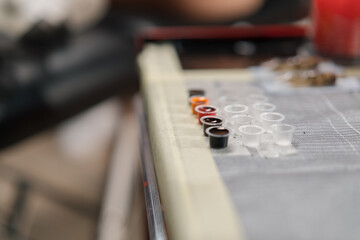 Close-up - tattoo equipment in a tattoo studio, tattoo machine needles