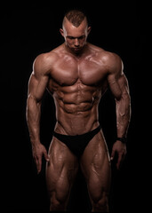 Fototapeta na wymiar Muscled male model posing in studio