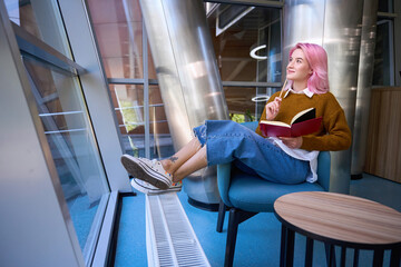 Pretty lady resting and reading the diary