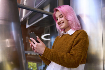 Pretty female standing near wall and talking