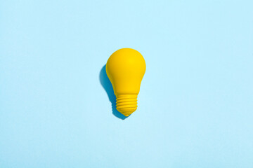 light bulb success business ideas creativity and inspiration concepts on blue background. Goal achievements flat lay minimalist composition