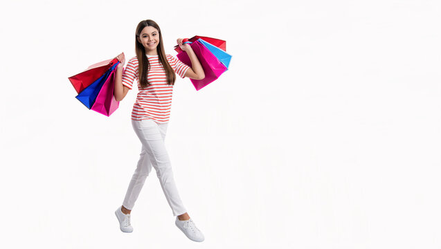 shopaholic girl holding shopping bag in studio, copy space. shopaholic girl go shopping
