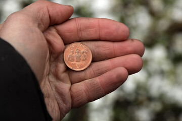 Coin two pence in hand