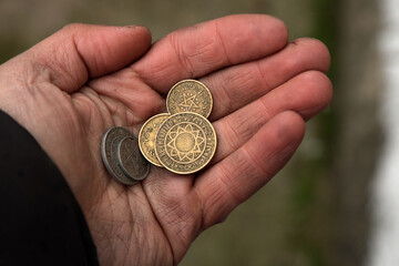 Old Moroccan coins in hand