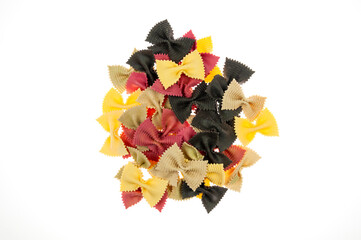 A bunch of colorful pasta in the form of butterflies on a white background. - Powered by Adobe