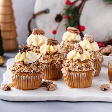 Candied pecan cupcakes with cream cheese frosting and caramel