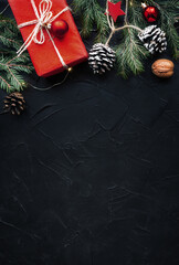 Vertical Christmas banner with many gift boxes with paper decorations on black plaster background....