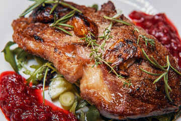 Sirloin steak with cranberry sauce and vegetable salad with thyme, rosemary and garlic