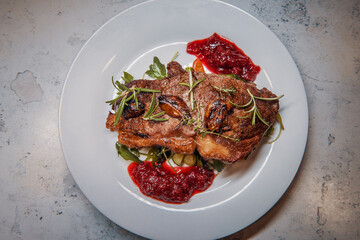 Sirloin steak with cranberry sauce and vegetable salad with thyme, rosemary and garlic