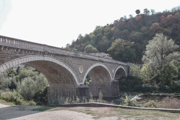 Fototapeta na wymiar Bridge crossing a river in nature with trees in Bulgaria.