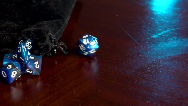 A 20 sided blue dice spinning.