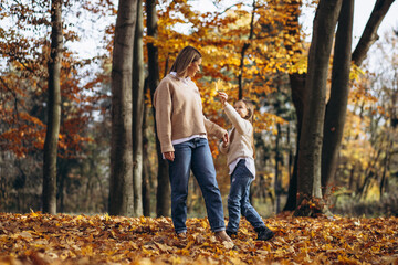 Mother with little daughter in autumn park