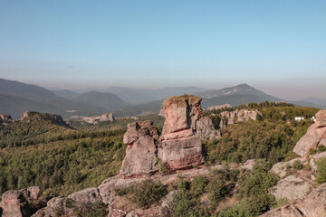 Fototapeta na wymiar Stunning nature with high rocks and hills in Belogradchik in Bulgaria. Green nature and rocks in the wild with outstanding views.