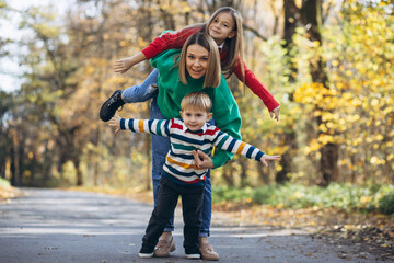 Fototapeta premium Mother with children walking in park