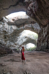 A woman wandering in the stunning Devetshka cave in Bulgaria.