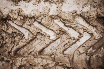 Tyre mark background. Tire track shape. Trail lines on dry brown sand pattern. Road construction site backdrop. Heavy machinery imprint. Wet mud vehicle wheel shape.