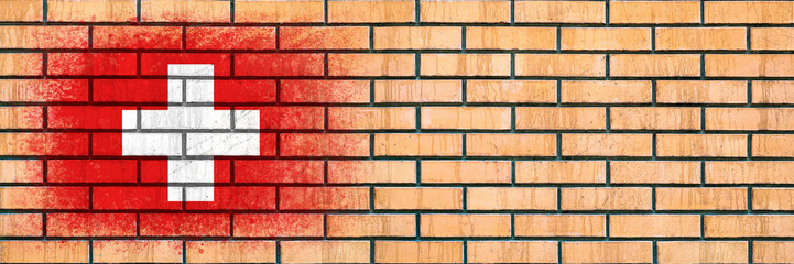 Flag of Switzerland. Flag painted on a brick wall. Brick background. Copy space. Textured background