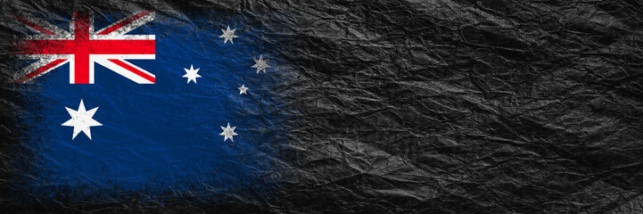 Flag of Australia. Flag is painted on black crumpled paper. Paper background. Copy space. Textured background