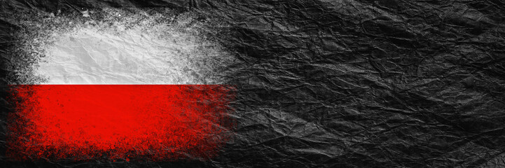 Fototapeta na wymiar Flag of Poland. Flag is painted on black crumpled paper. Paper background. Copy space. Textured background