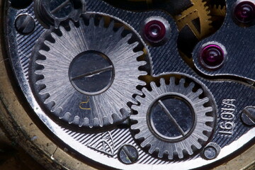 Close view of a watch mechanical wristwatch mechanism with wheels and ruby stones