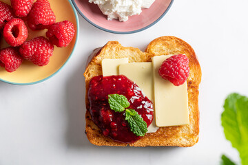 Open Sandwich with Brioche bread slices, organic butter and raspberry jam