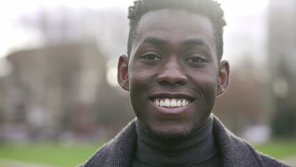 Handsome black African man smiling outside during daylight