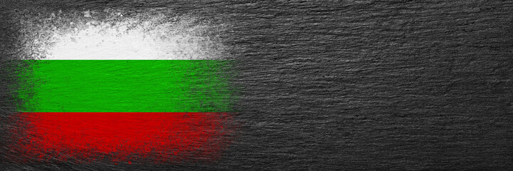 Flag of Bulgaria. Flag is painted on black slate stone. Stone background. Copy space. Textured background