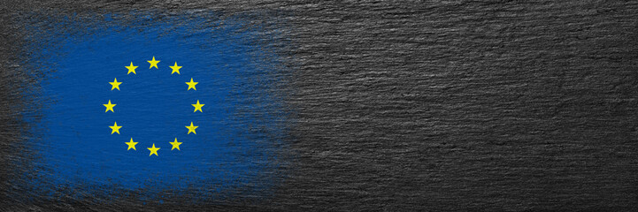 Flag of European Union. Flag is painted on black slate stone. Stone background. Copy space. Textured background