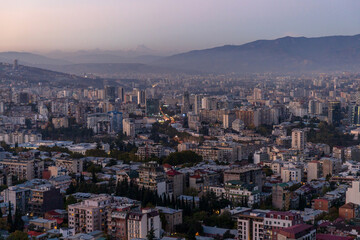 view of a large modern city among the mountains at dusk. Tbilisi. Georgia