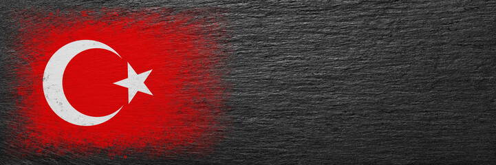 Flag of Turkey. Flag is painted on black slate stone. Stone background. Copy space. Textured background