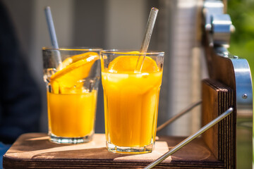 two glasses with orange juice