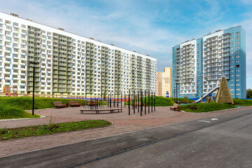 view of the residential complex courtyard with a playground and a metal slide for children