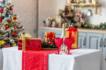 Champagne bottles and glasses on the table against the backdrop of Christmas decorations