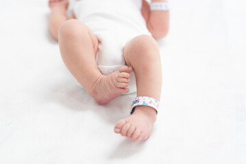 A newborn baby who has just been cleaned up and dressed after birth.