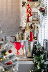Champagne bottles and glasses on the table against the backdrop of Christmas decorations