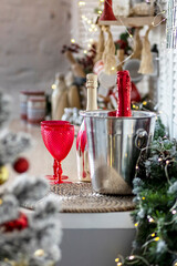Champagne bottles and glasses on the table against the backdrop of Christmas decorations