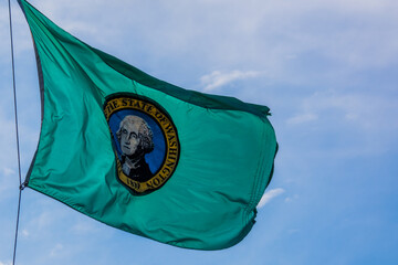 Washington State evergreen George Washington flag flying in strong breeze