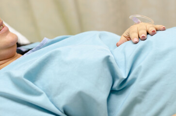 A pregnant woman in labor, lying in a hospital bed waiting for her baby to be born.