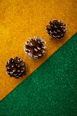 New Year's decor and cones on a green and yellow background
