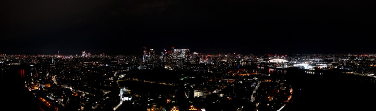 Beautiful cityscape of modern urban London metropolis at night, with lightened skyscrapers, towers, and buildings, aerial panorama view. © 24K-Production