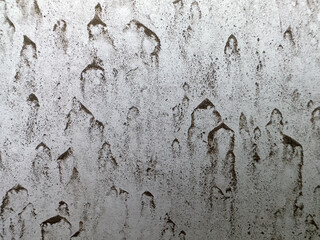 Mud splatters on white hood of car background texture, close up, detail. Dried mud from rain drops of dirt of light color on white surface, need washing concept